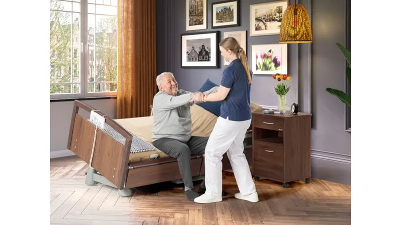Carer using the Latera Neo to help a resident mobilise